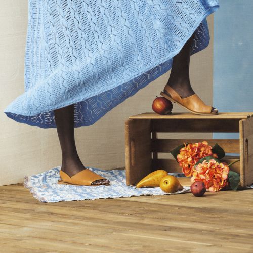 Model wearing tan Bueno Hayden Sandals styled with a blue dress, showcasing versatile summer footwear handmade in Istanbul.