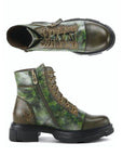 Side and top views of Women's L'Artiste Carnelian Combat Boot in green camo leather, showcasing zipper detail and rugged sole design.
