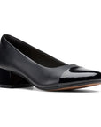 Black pump with patent toe cap and patent low heel.