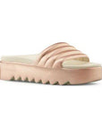 Pool Party Slide Sandal in Rose Metallic. A rose gold sandal with a 1.5 inch platform outsole, designed with deep grooves. Footbed is taupe.