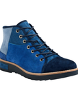 A high-top patchwork ankle boot featuring suede panels in varying shades of blue, with blue laces and a black outsole.