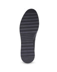 Light treaded black rubber outsole of a wedge heel loafer.