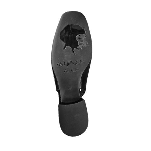 Outsole view of black Django & Juliette Viraz Slingback Heels showing engraved silhouette and quote, with square toe and block heel.