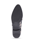 Black outsole of dress shoe with low heel.