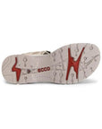 An Ecco treaded outsole with red accent designs and red logo in middle.