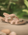 Comfortable El Naturalista N5079 Backstrap Sandal in pink displayed outdoors, highlighting its natural materials and ergonomic design.