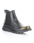 A black leather Chelsea boot with dual elastic side goring, bronze brushed toe cap, and a low lugged rubber outsole.