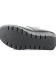 Black lugged wedge outsole with Fly London branding heel and fly logo near toe.