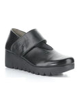 A black Mary-Jane style shoe with a Velcro strap and a thick lugged rubber sole.