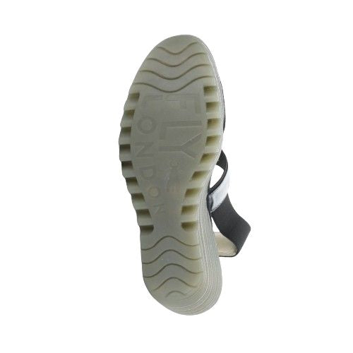 Outsole view of Women's FLY London Yaco Crossover Wedge Sandal featuring signature lugged sole for traction and branded detailing.