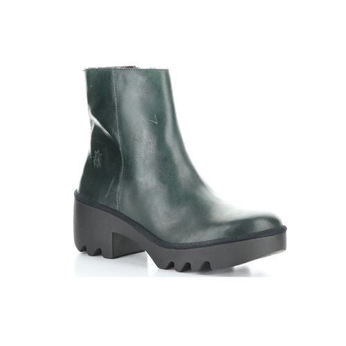 A deep green ankle boot with a black rubber chunky low heel outsole.
