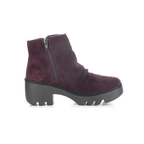 Profile of a purple ankle boot with a heel, made of genuine leather, with a zipper on the side and a lugged rubber sole.