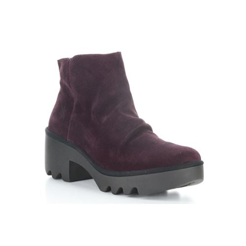A purple ankle boot with a heel, made of genuine leather, with a zipper on the side and a lugged rubber sole.