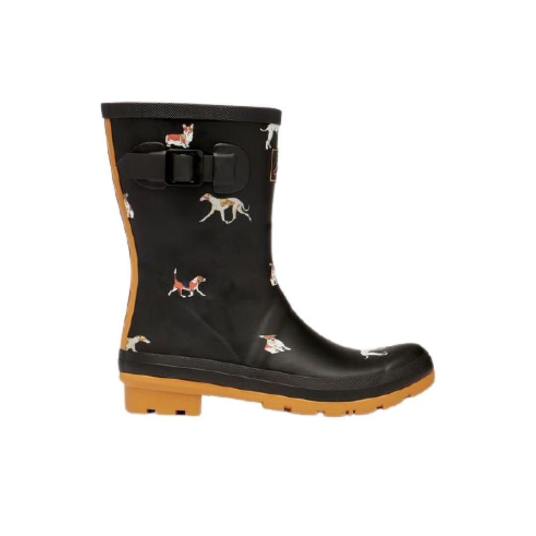 Molly Mid-Height Welly in Black Dog. Black rubber boot with yellow accents and a yellow outsole. Upper has various dogs painted on.