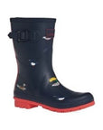 Molly Mid-Height Welly in Navy Ducks. Navy blue rubber boot with red accents and a red outsole. Upper has a painted-on duck pattern.