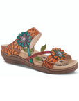Women's L'Artiste Aymee Sandal in orange with vibrant floral accents, hand-painted leather, and contrast stitching on a wedge sole.