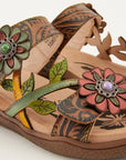 Close-up of the Women's L'Artiste Aymee Sandal highlighting colorful hand-painted leather flowers and leaf accents on the straps.