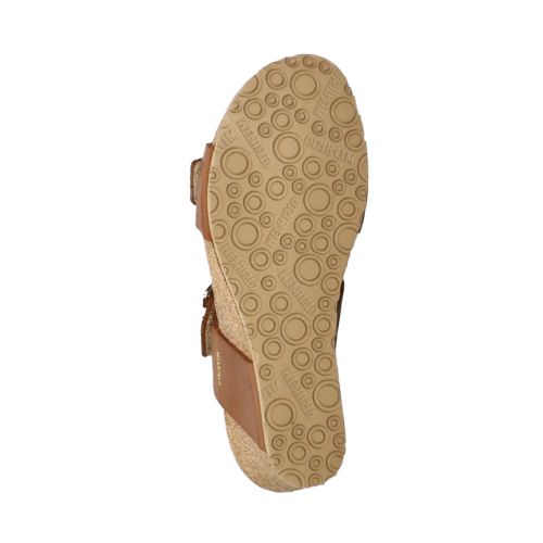 Outsole view of tan Women's Mephisto Lissandra Wedge Sandal. Beige rubber sole with circular tread design for enhanced grip.