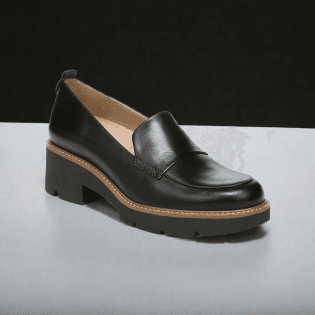Side angle of Women's Naturalizer Darry Loafer in black leather with contrast stitching and chunky heel for modern appeal.