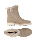 Pair of beige winter boots with fur trim, detail stitching and white lugged outsole.