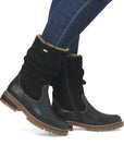 Black Remonte D0B80 women's winter boots worn with jeans, highlighting mid-calf fit, waterproof design, and cozy lining.
