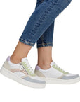 Model wearing Women's Remonte D0J01 lace-up sneakers in pastel tones, highlighting their casual style and supportive fit.
