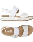 Pair of White backstrap sandals with a zig-zag striped gold strap and white square buckle on white and gold striped platform outsole.