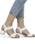 Model wearing Women's Remonte D1K51 white leather sling-back heels with jeans, demonstrating versatile and fashionable everyday wear.