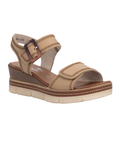 Tan wedge sandal with brown buckle, accent zig-zag stitching, tan Remonte logo'd footbed and tan-white outsole.