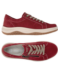 A pair of red suede sneakers with a side zipper, beige laces, grey Remonte logo'd footbed, white accent stitching, cream midsole, and a brown tan outsole.