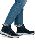 Navy blue sneaker boots worn with blue jeans.