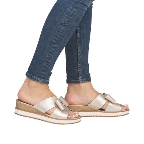 Beige Rieker D6456 platform wedge sandals worn with jeans, highlighting their versatile and fashionable design for women.