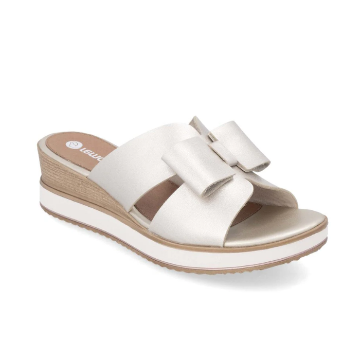 Women's Rieker D6456 slide platform wedge in beige with bow accents and wood-textured heel, perfect for summer outfits.