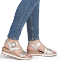 Gold strapy wedge sandals worn with jeans.