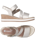 Pair of Gold backstrap wedge sandals with three velcro straps, decorative silver buckle, white and wood grain midsole and Remonte logo'd tan footbed.