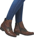 Model wearing brown Women's Remonte D6882 lace-up boots with jeans, perfect for casual and dressy fall ensembles.