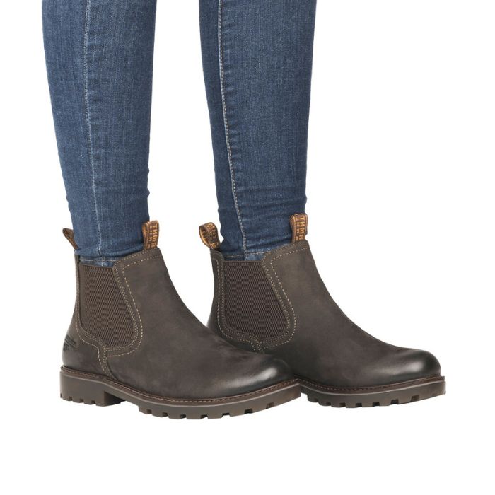 Model wearing olive Women's Remonte D8472 Chelsea Boots with jeans, showcasing waterproof ankle boot style and comfort for daily wear.