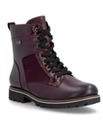 A dark burgundy lace-up boot with black laces, black metal eyelets, suede and patent accents and a black lug outsole.