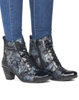Model wearing Women's Remonte D8797 heeled ankle boots with jeans, showcasing stylish waterproof design and comfortable heel height.