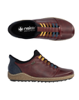 Pair of deep red slip-on shoes with a black heel tab, colorful elastic laces in yellow, brown, and blue, black Rieker logo'd footbed, a beige textured midsole and black treaded outsole.