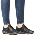 Brown Remonte R1402 lace-up sneakers worn with jeans, offering a stylish and waterproof option for casual women's shoes.