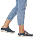 Model wearing navy Lace-up Sneakers with jeans.
