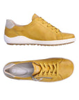 Top and side views of yellow Women's Remonte R1432 Lace-Up Sneaker featuring soft leather upper and flexible, cushioned sole.