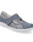 Light blue Mary-Jane shoe with floral line drawing on side panels and white outsole.