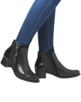 Model wearing black Women's Remonte R5172 Ankle Boots with jeans, highlighting the boot's sleek leather design and mid-heel style.