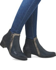 Model wearing navy Women's Remonte R5172 Ankle Boots with jeans, showcasing the boot's elegant leather finish and comfortable heel.