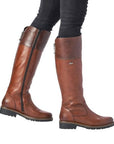 Model wearing brown R6581 Tall Boots with dark jeans, showcasing stylish fit, water-repellent leather, and side zipper.