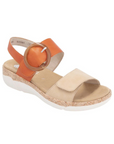 Rieker R6853 Backstrap Sandal in tan and orange with large round buckle, designed for comfort, flexibility, and summer style.