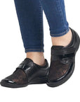 Model wearing lace-patterned black Women's Remonte R7600 Velcro Shoes, perfect for casual comfort and stylish support.