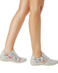Model wearing silver multicolor Remonte R7637 Lace-Up Sneakers, styled for casual wear with stretch material for added comfort.